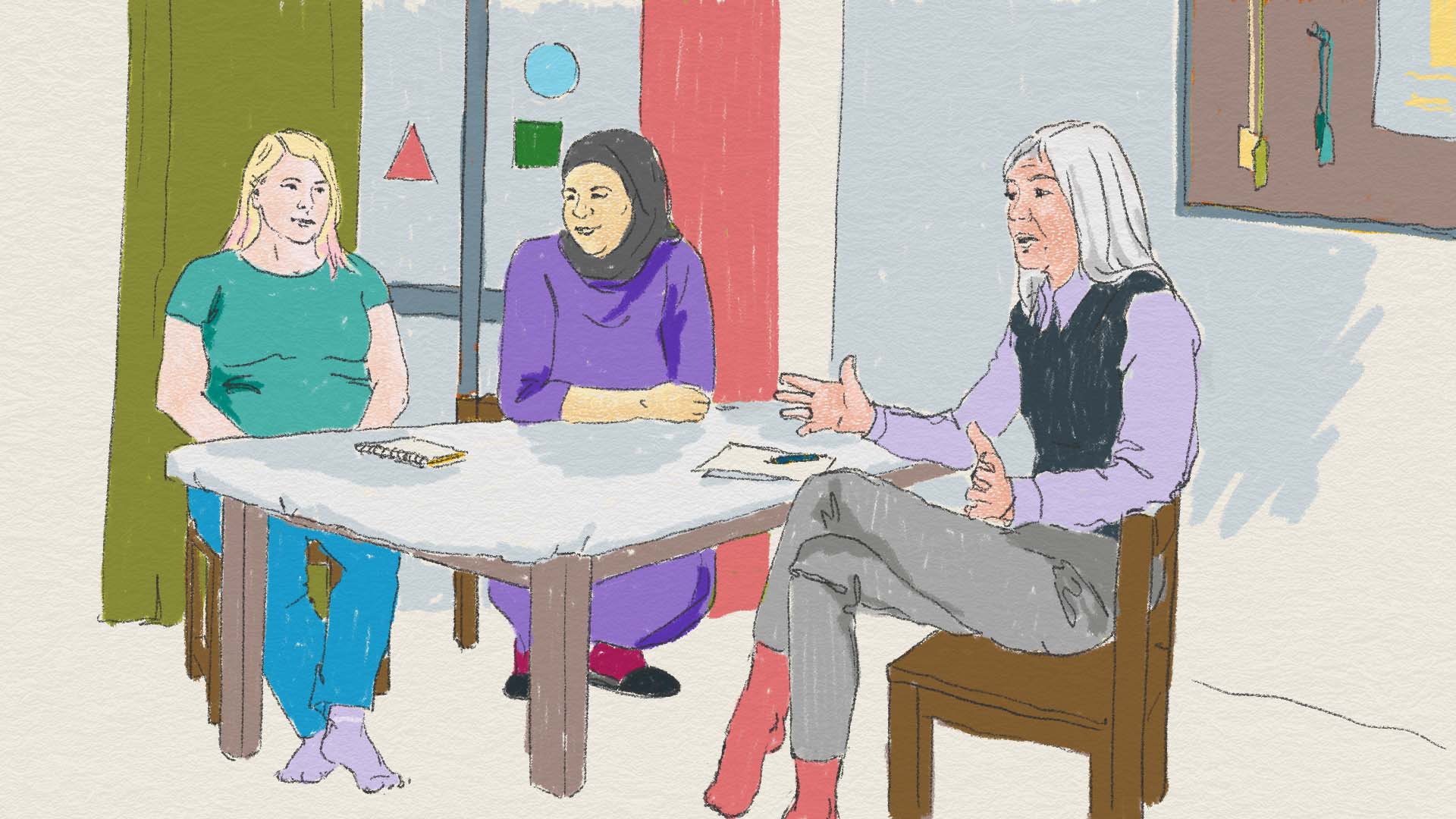 Kvinnor sitter runt ett bord och samtalar