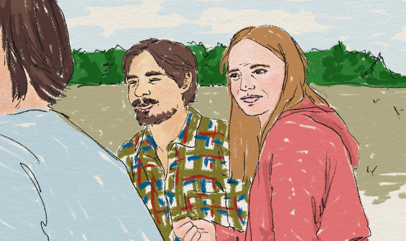 Personer framför en åker och träd