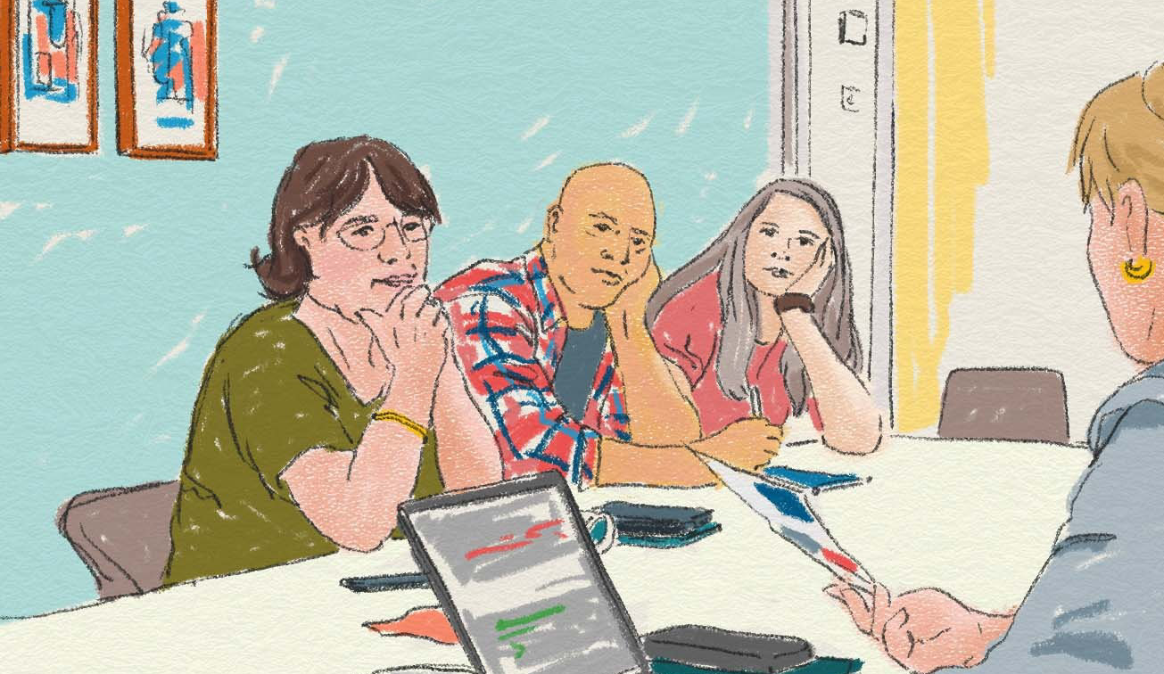 Personer har möte runt ett bord