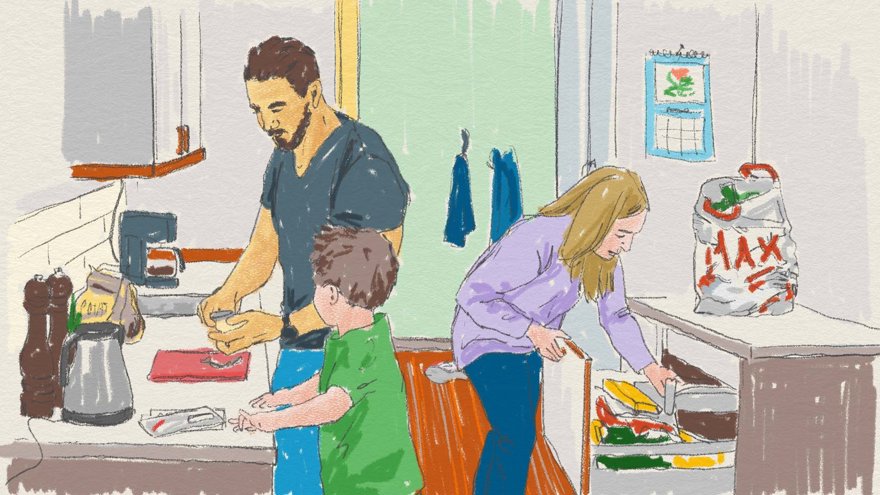 Två vuxna och ett par arbetar i ett kök