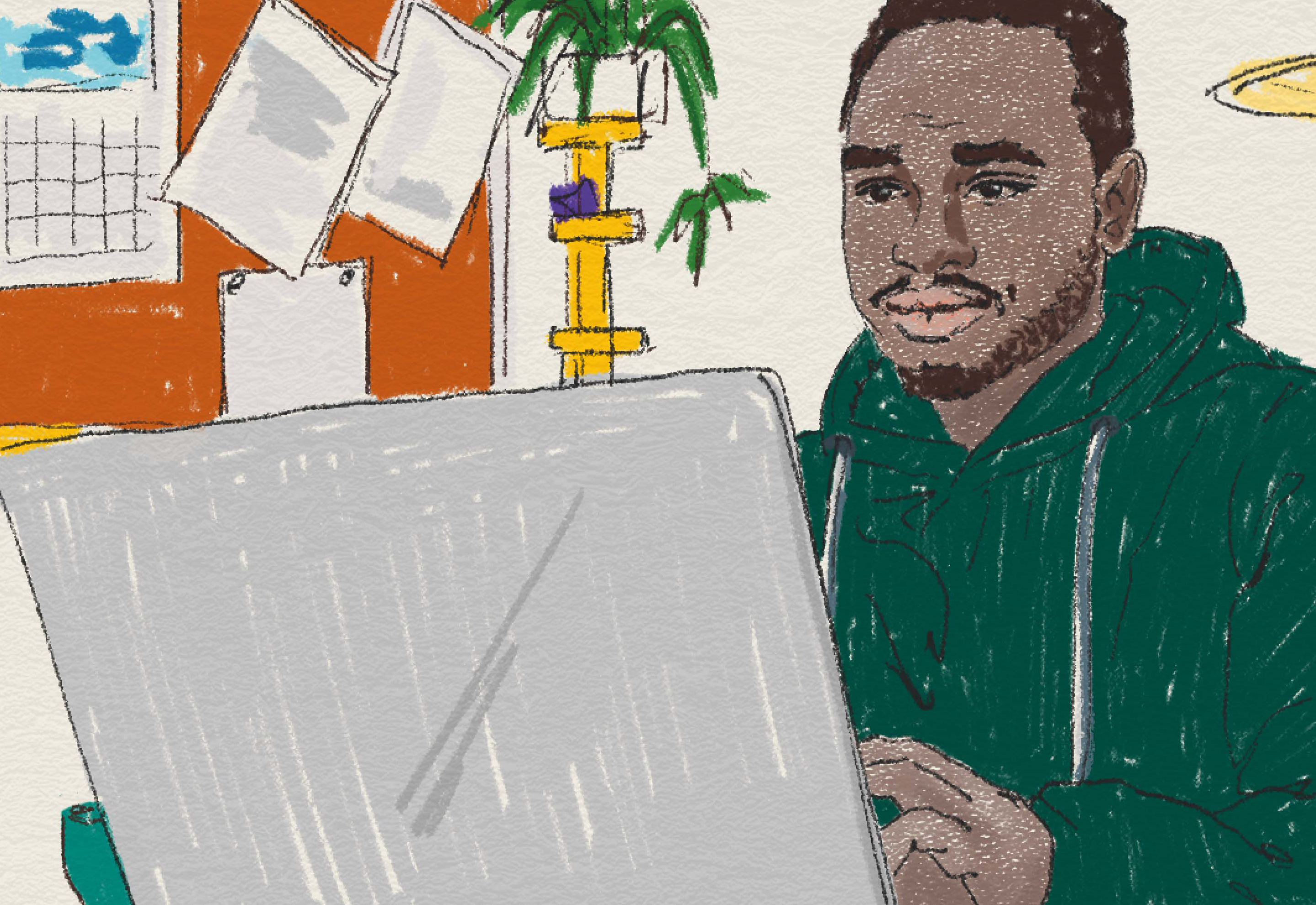 Man sitter framför sin dator på ett kontor