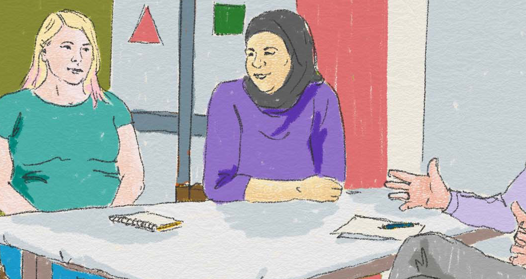 Kvinnor sitter runt ett bord