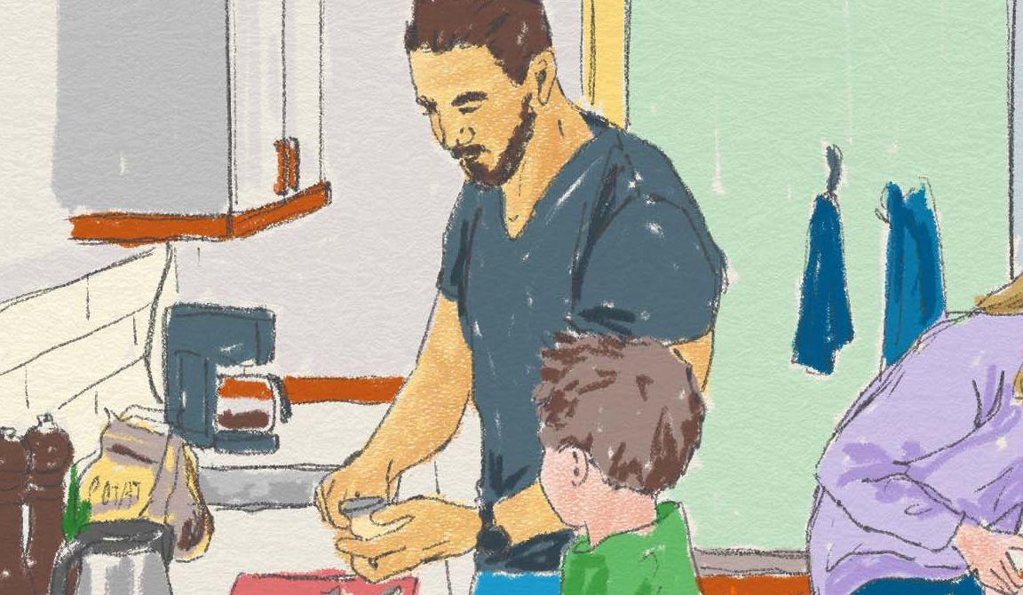 En pappa och barn lagar mat i ett kök