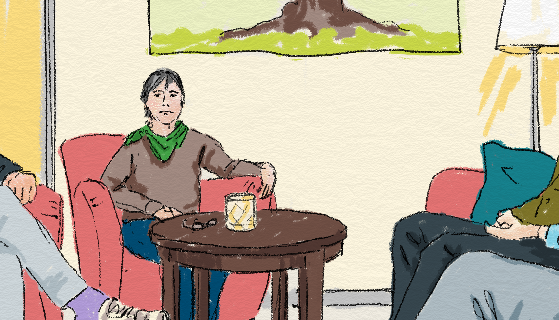 Flera personer sitter i fåtöljer runt ett bord